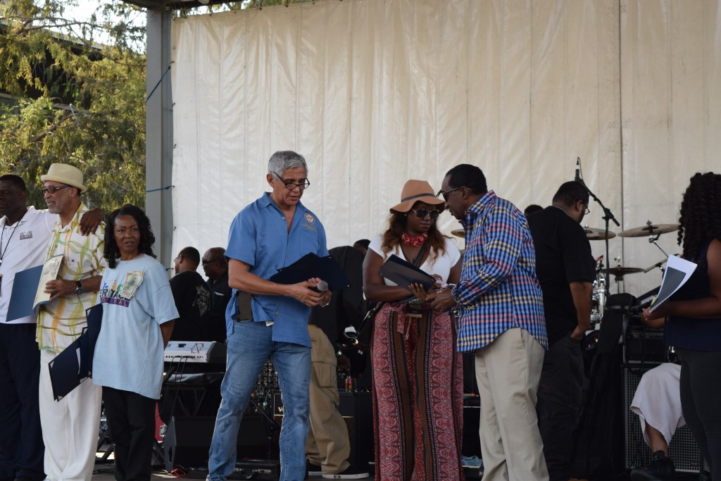 Houston City Council Member Robert Gallegos presents Wash Allen with a special recognition certificate.
